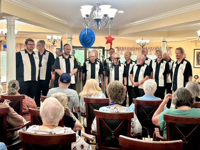 A vocal group performing for Autumn Ridge residents seated in the dining room