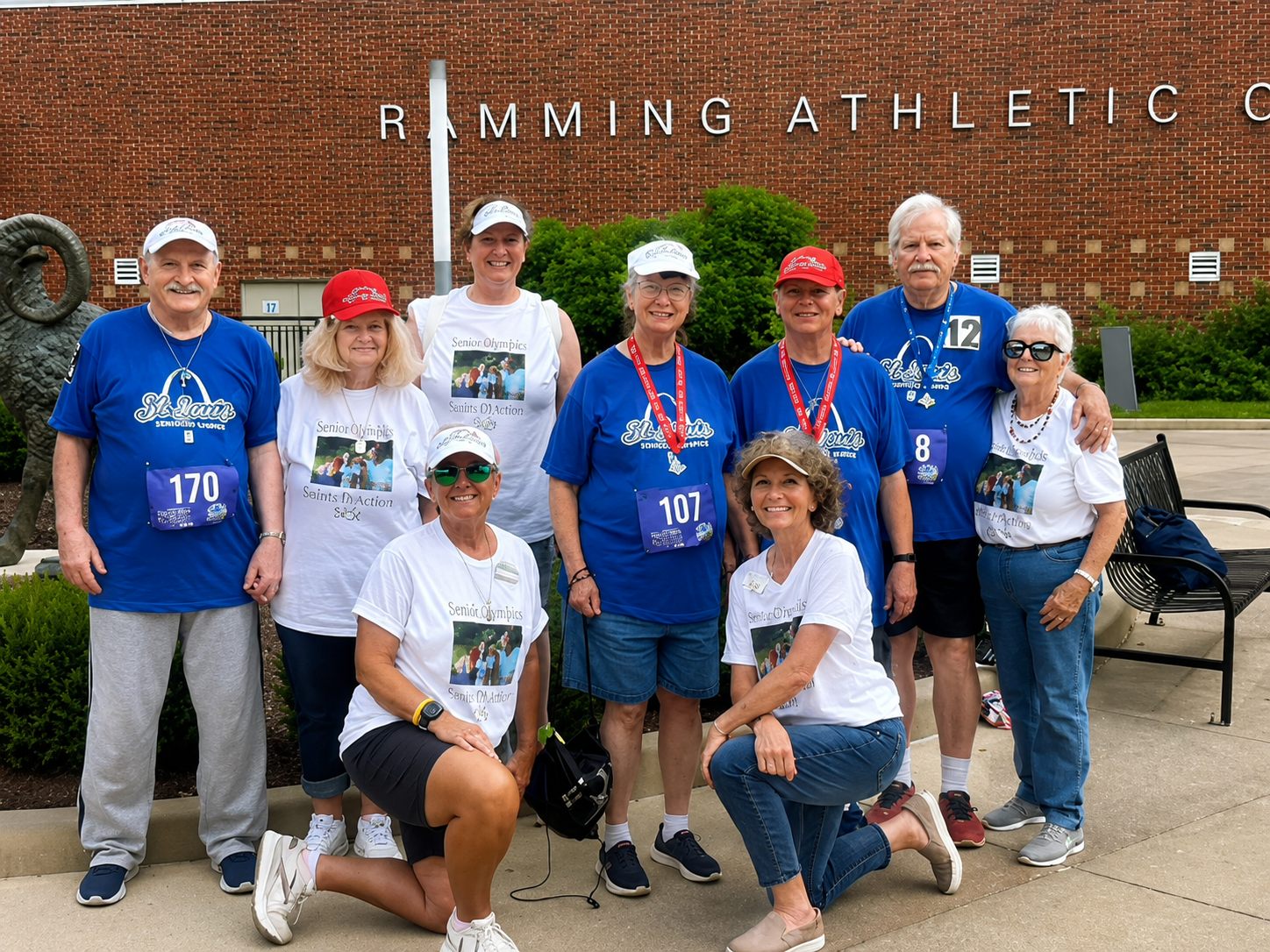 Autumn Ridge residents at the St. Louis Senior Olympics, some wearing medals, posed in front of the Ramming Athletic Center
