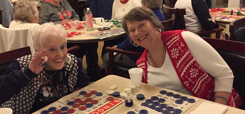Senior friends playing bingo at Autumn Ridge Residences