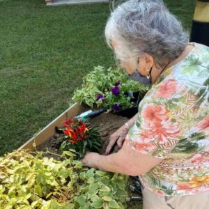Autumn Ridge Residences | Senior tending to the garden